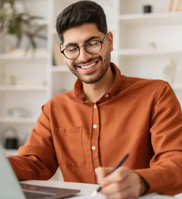 Smiling student working on a laptop